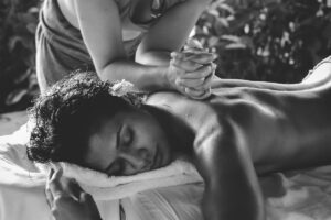 A person receiving a restorative back massage from an expert therapist