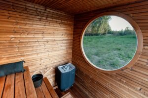 Interior of a wooden sauna with a round window.