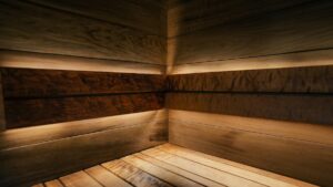 Corner of a wooden sauna with warm ambient lighting
